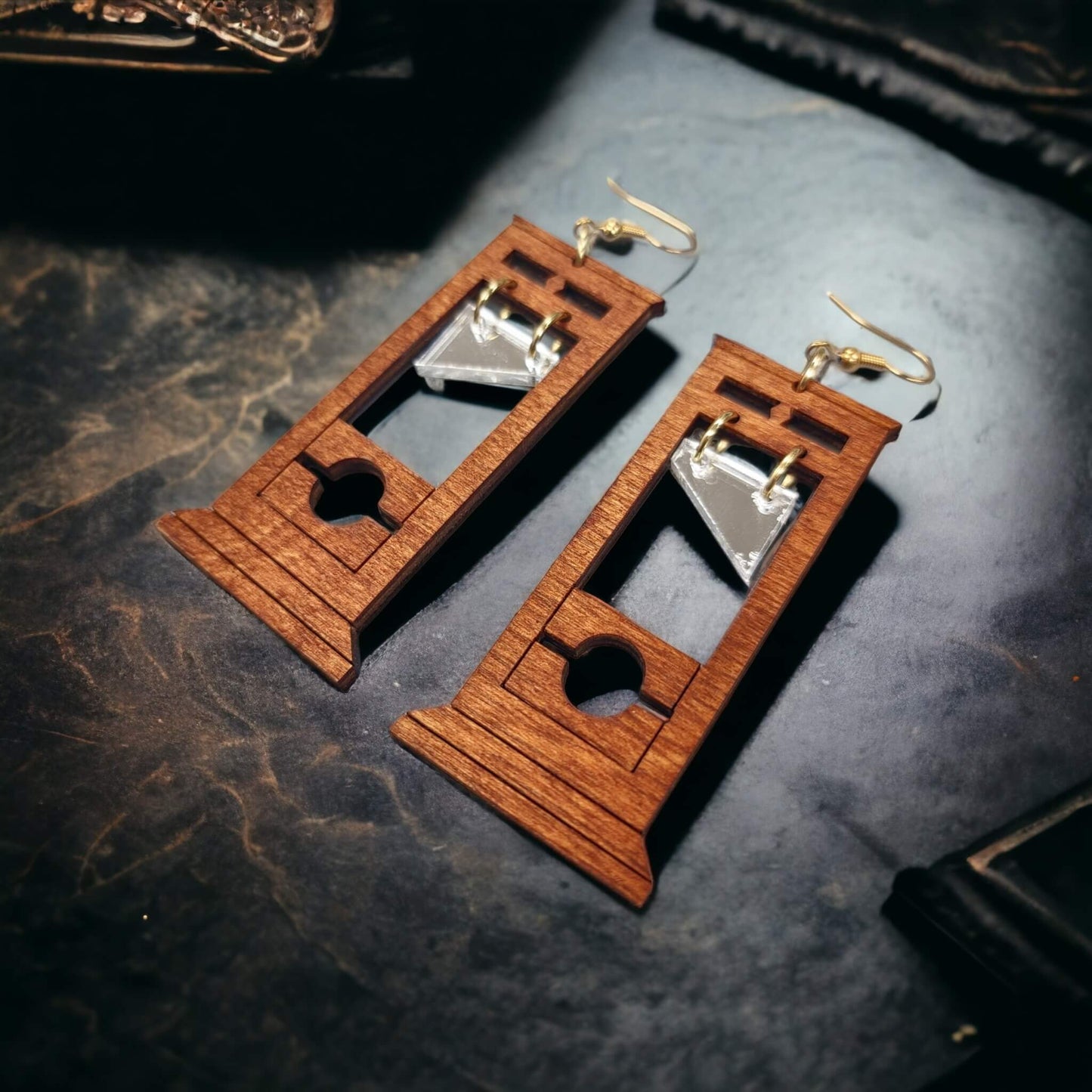 A picture of our wooden guillotine earrings with Cherry finish.