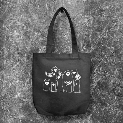 our accent tote bag featuring our original characters The Grims.